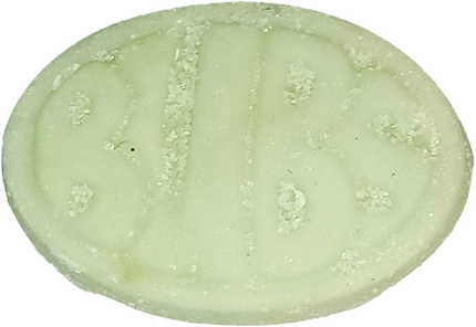 Close-up of a greenish, oval-shaped pill with embossed letters.