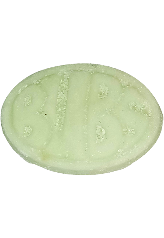 Close-up of a greenish, oval-shaped pill with embossed letters.