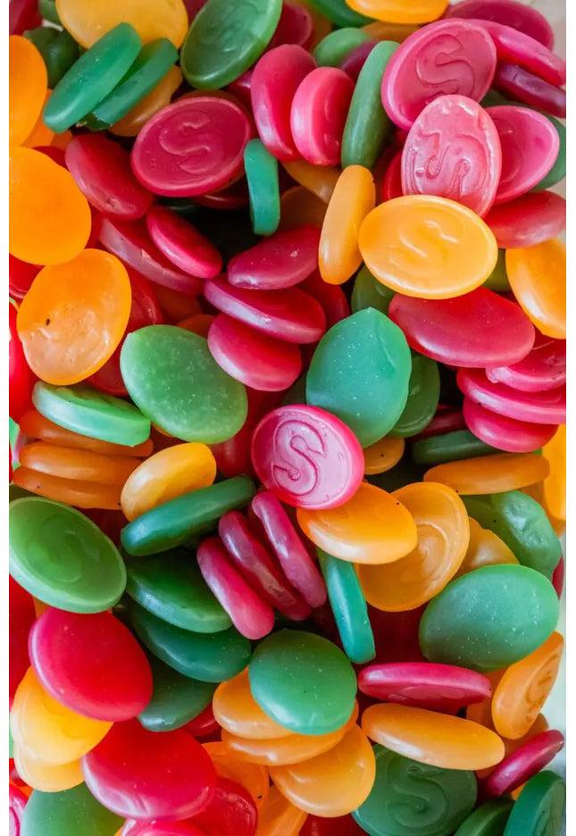 Colorful oval-shaped candy pieces in various bright colors.