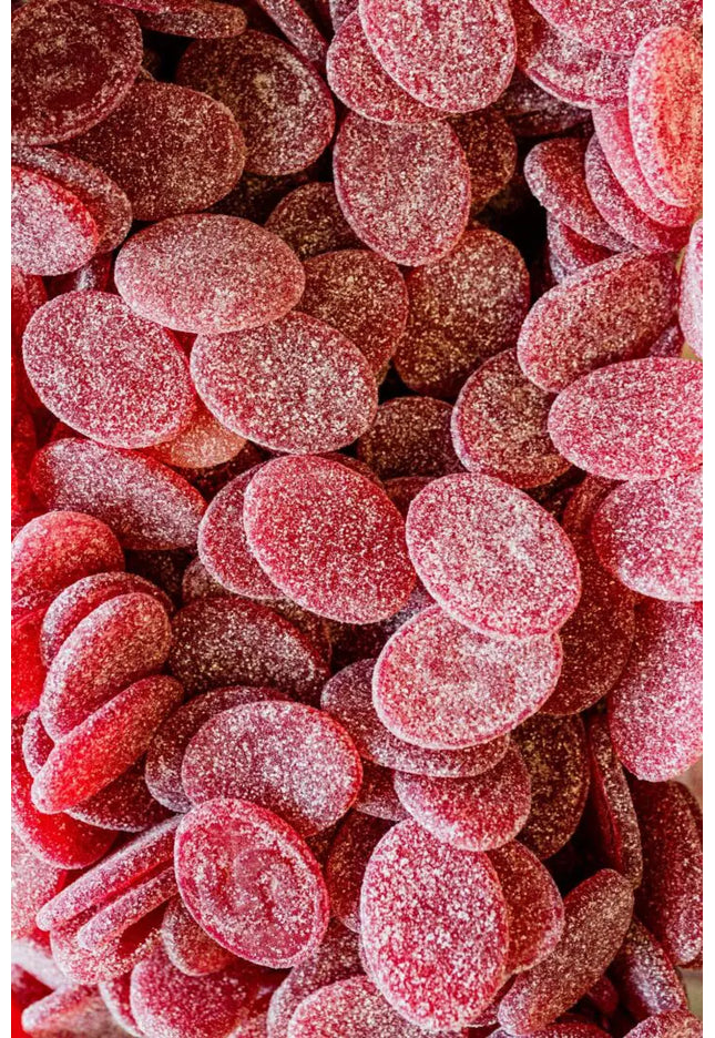 Close-up of red, sugar-coated gummy candies.