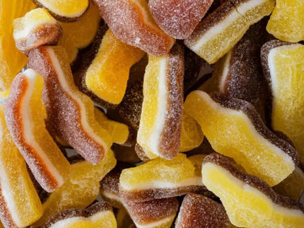 Close-up of colorful gummy cola bottle candies coated in sugar.