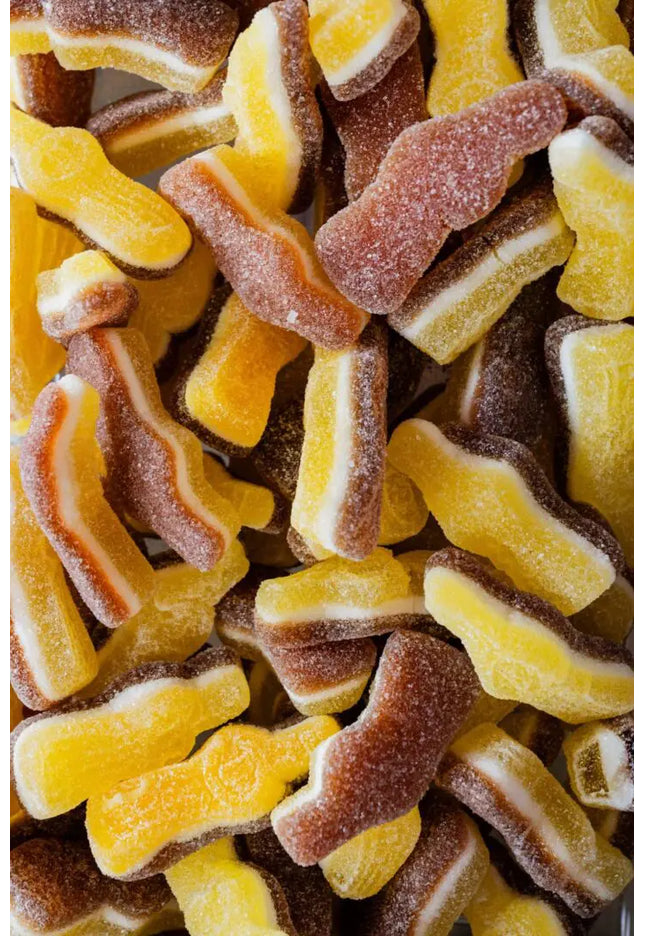 Close-up of colorful gummy cola bottle candies coated in sugar.