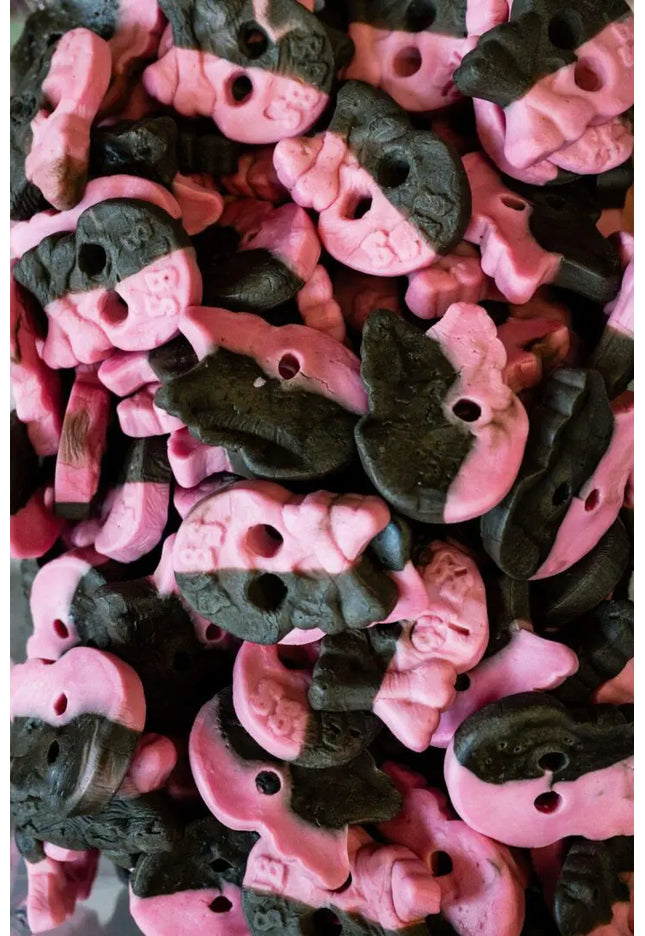 Close-up of black and pink gummy candies.