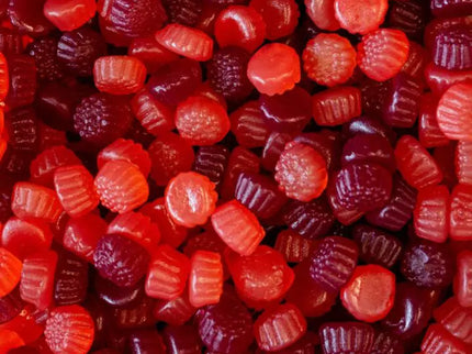 Close-up of assorted red and purple gummy candies with ridged patterns.