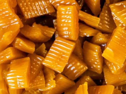 Close-up of caramel candy pieces with textured grooves.