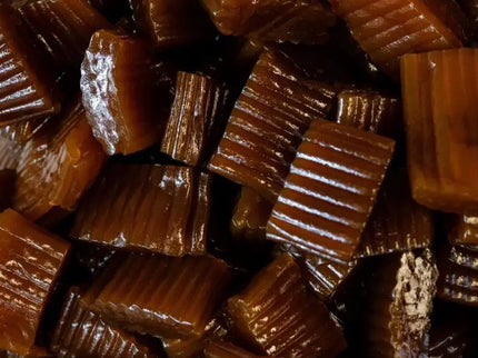 Close-up of glossy, ridged caramel candies.