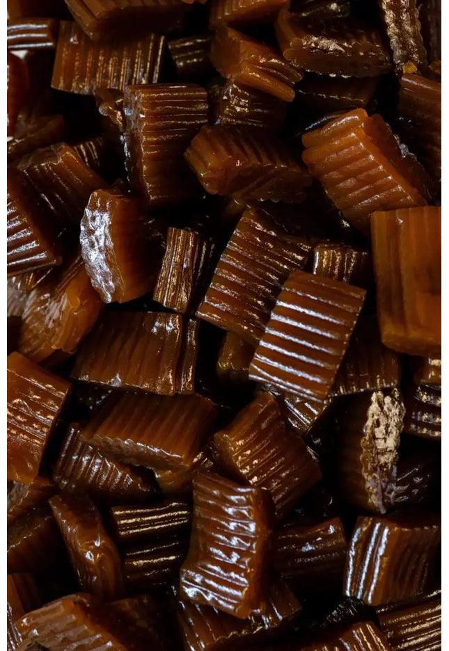 Close-up of glossy, ridged caramel candies.