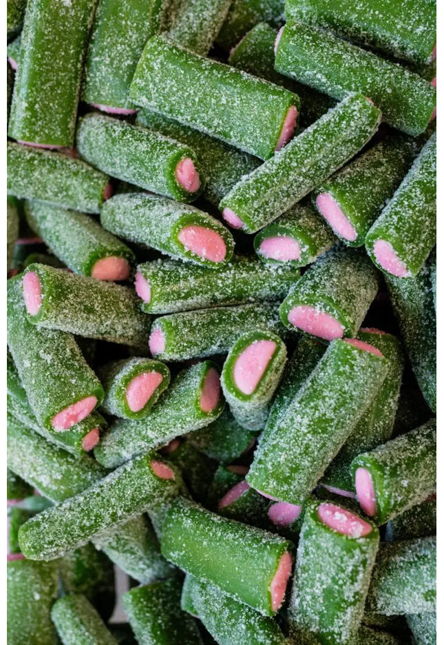 Green and pink sugar-coated candy sticks with a textured surface.
