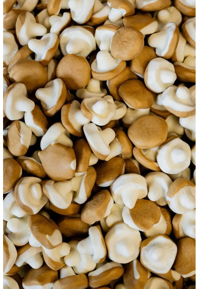 A pile of fresh brown mushrooms closely packed together.