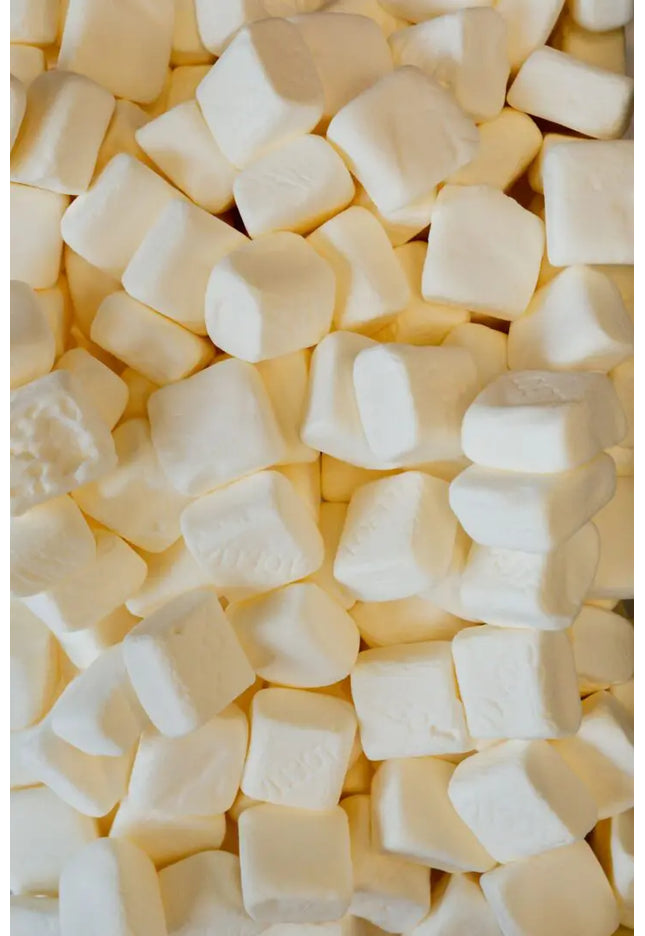 Close-up of white sugar cubes piled together.