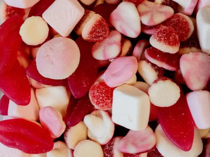 Assorted pink and white gummy candies in various shapes and sizes.