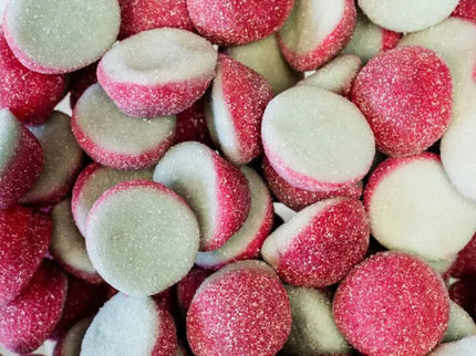 Close-up of pink and white candy drops with sugary coating.