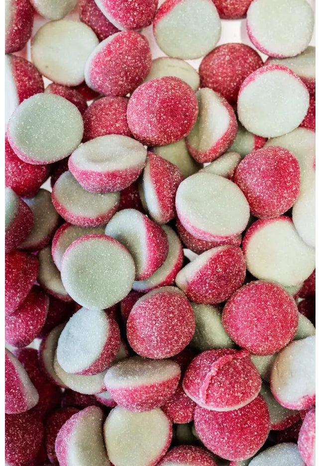 Close-up of pink and white candy drops with sugary coating.