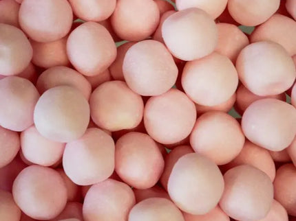 A close-up view of many round, pinkish spheres clustered together.