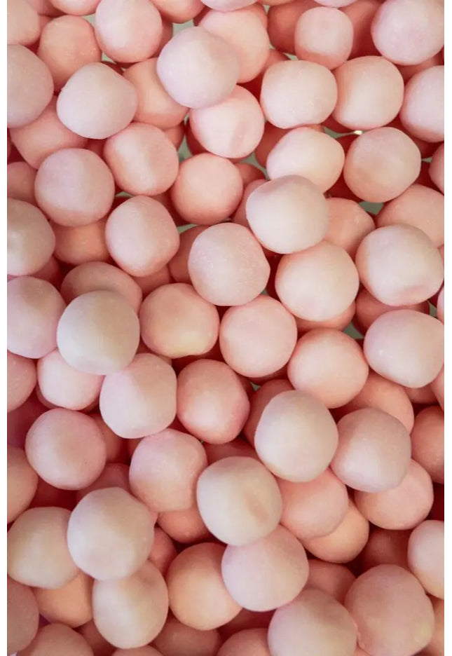 A close-up view of many round, pinkish spheres clustered together.