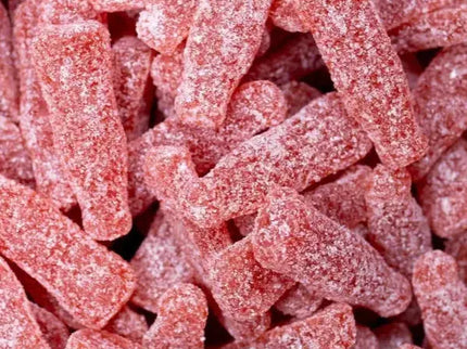 Close-up of red sour gummy candies coated in sugar.