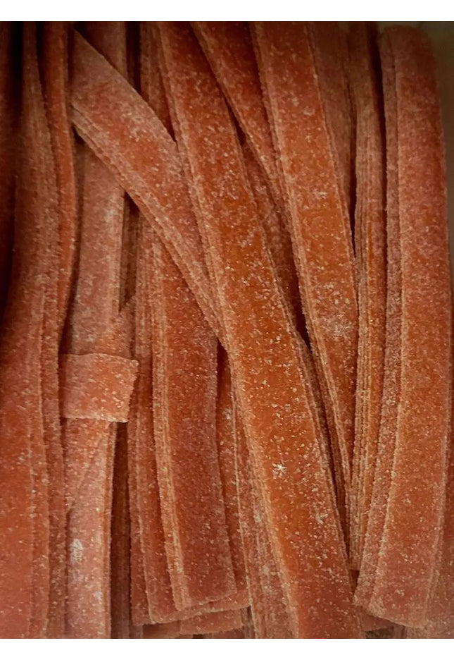 Red gummy candy strips with sugar coating.