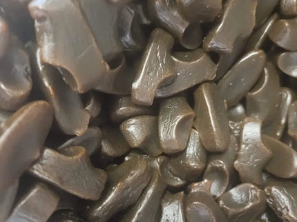 Pile of black licorice candy pieces.