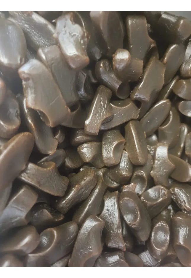 Pile of black licorice candy pieces.