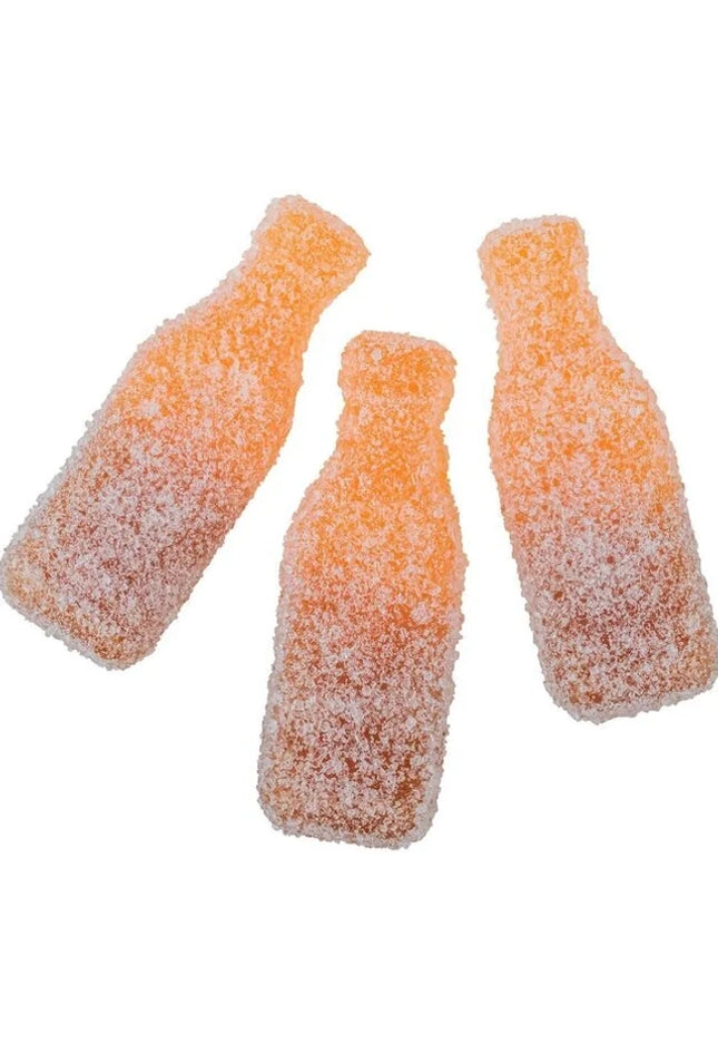 Three orange gummy candies shaped like soda bottles coated in sugar.