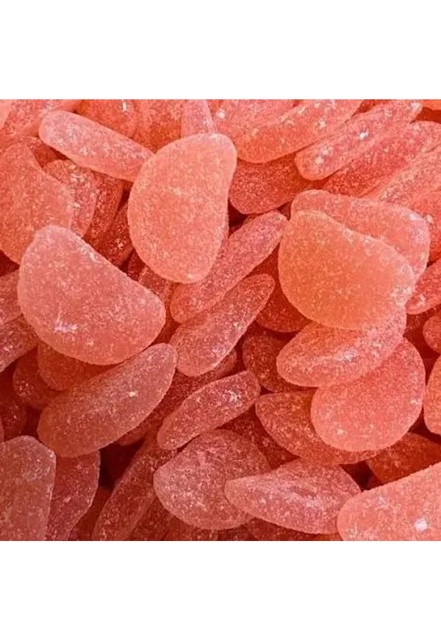Close-up of numerous pink sugar-coated Sour Watermelon gummy candies piled together.