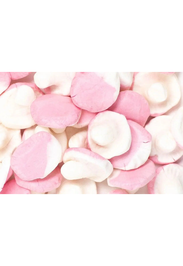 Close-up of pink and white gummy candies resembling mushrooms.