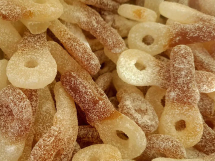 Sugary cola-flavored gummy candies piled together.