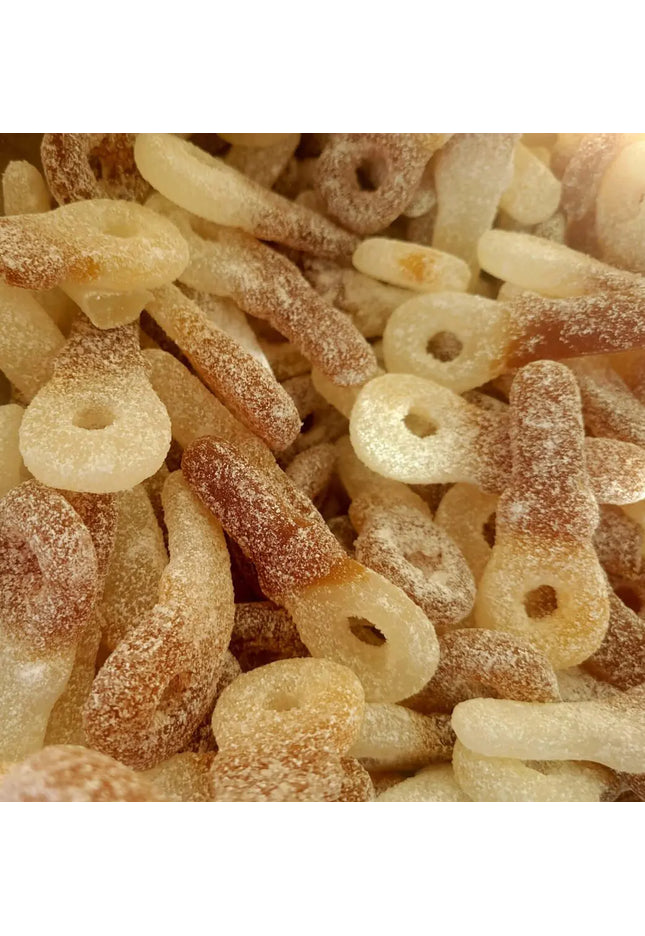 Sugary cola-flavored gummy candies piled together.